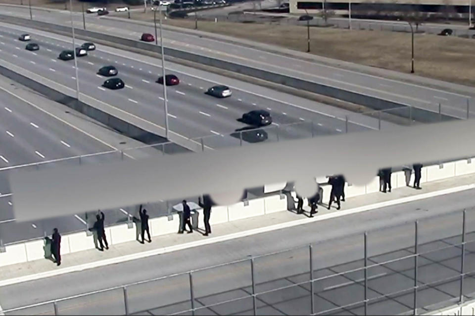 Demonstrators with Nazi flags leave Cincinnati-area highway overpass after residents confront them