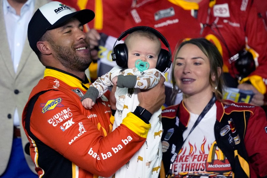 Bubba Wallace celebrates his 1st qualifier win at Daytona with his newborn